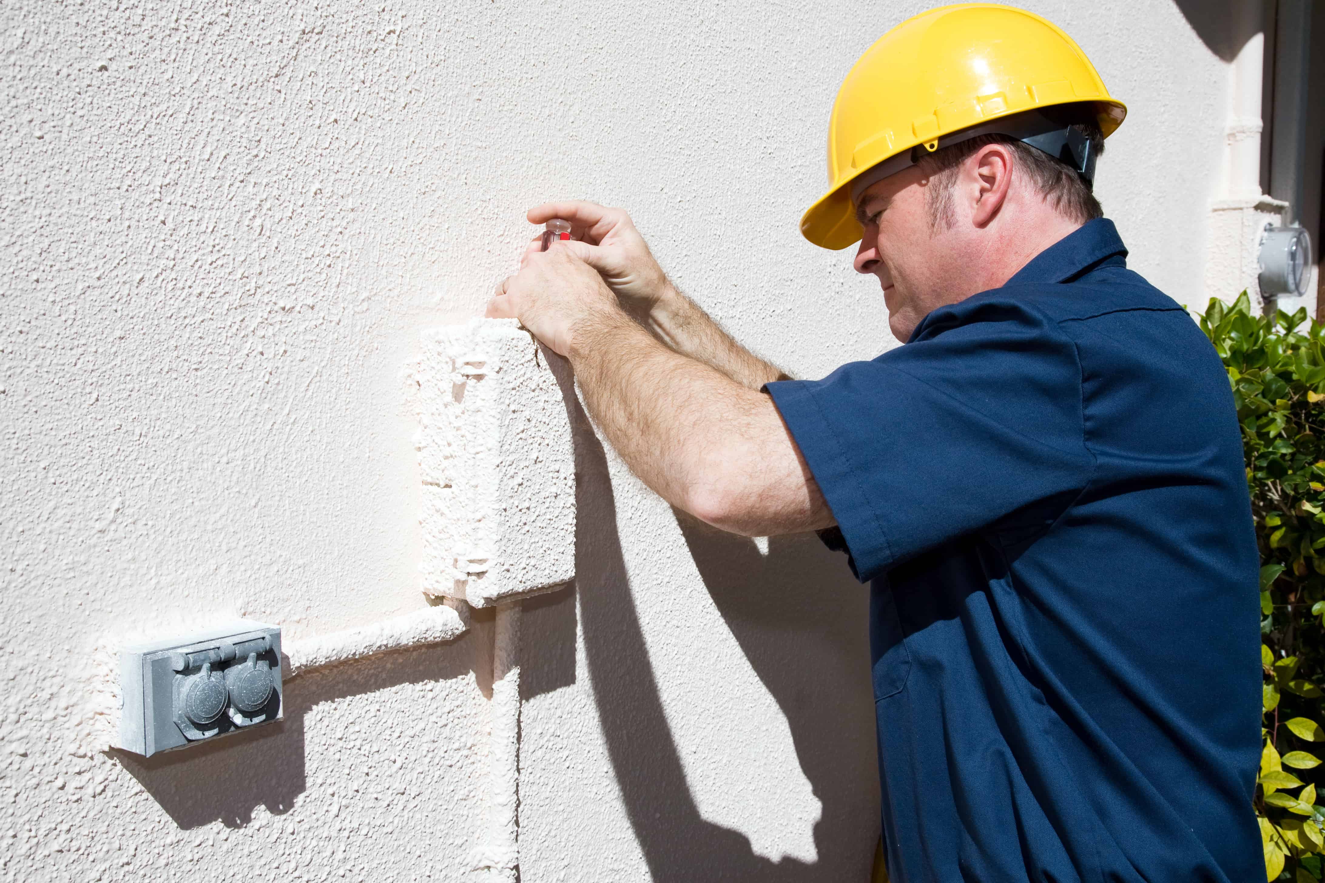 An electrician fixing something outside.