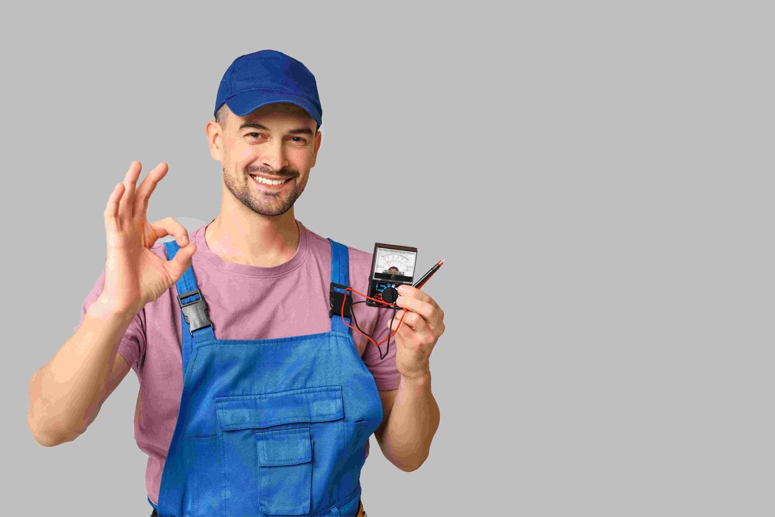 A man in the electrician uniform holding some device.