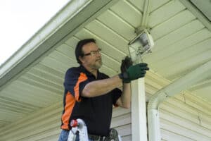 electrician fixing outdoor light.